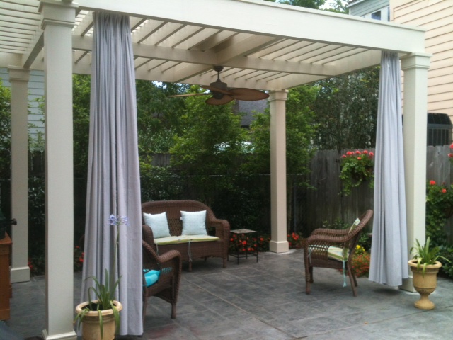 traditional white pergola with privacy curtains